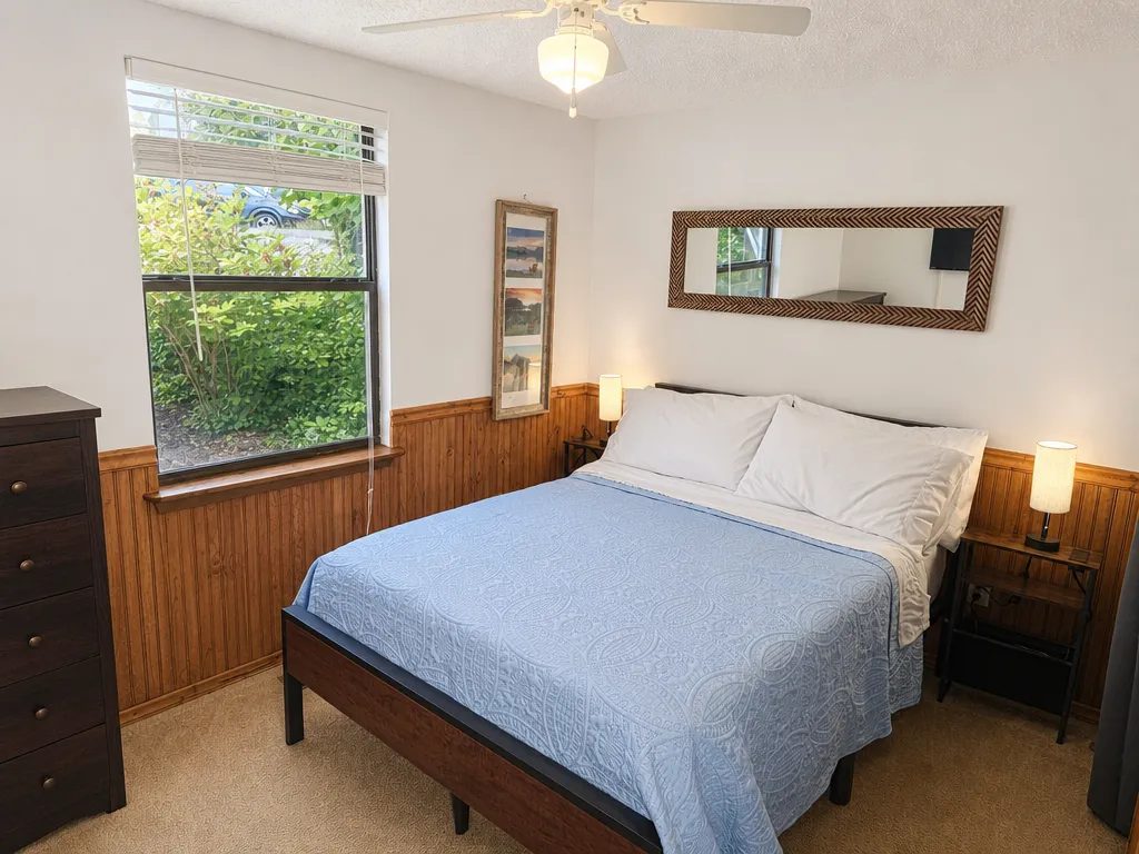 Double bedroom with two windows onto the trees