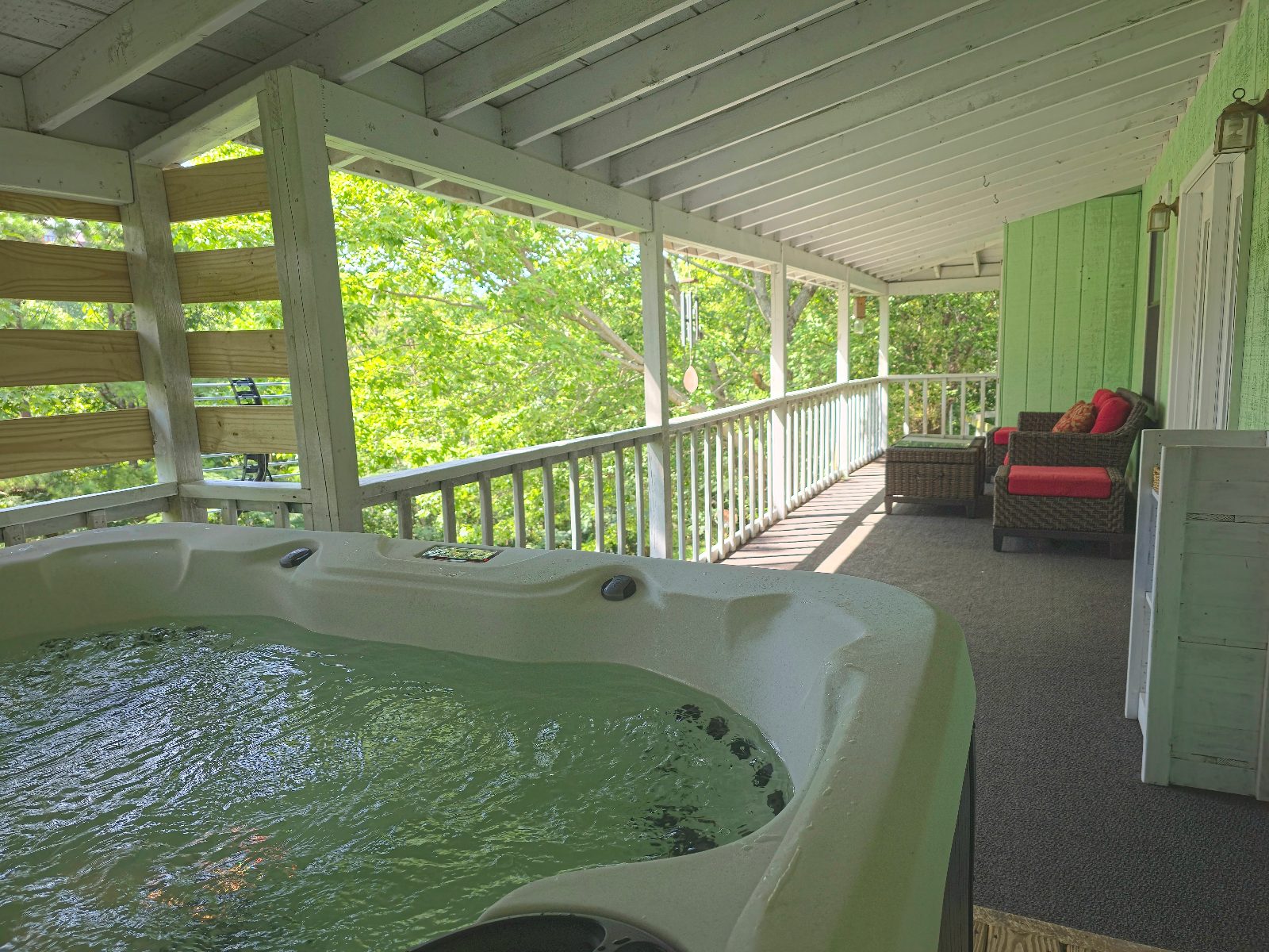 Hot tub and lounge chairs on the covered back porch