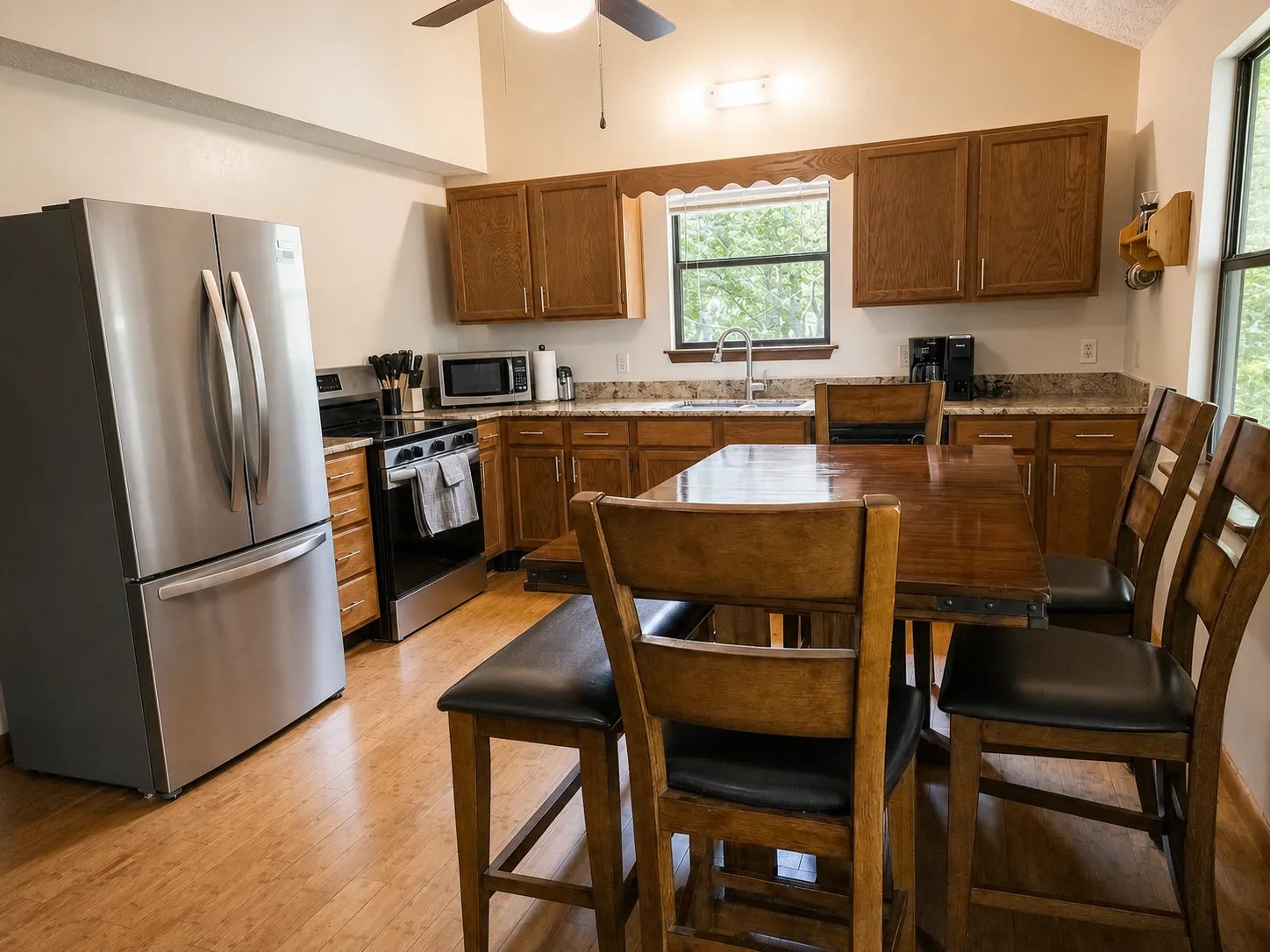Kitchen with oak cabinets, granite counters, and the counter-height table