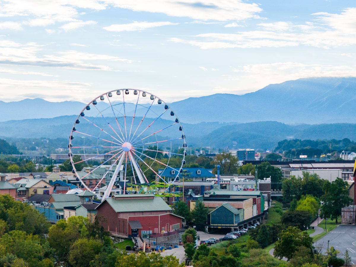 The big wheel at The Island in Pigeon Forge with the Smoky Mountains behind it