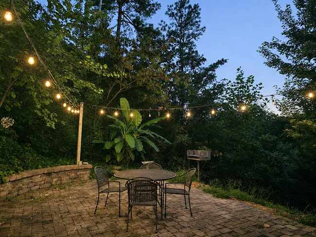 Brick-paved patio with the charcoal grill